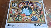 Front view of Disney Classics 1500-piece puzzle box featuring Cinderella in the center surrounded by other Disney characters in circular frames.