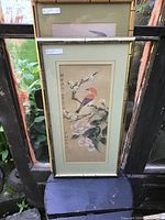 Photo of a framed Japanese watercolour painting of a red-breasted bird on a flowering branch with green matting and bamboo style frame