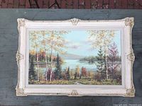 Full view of the oil painting framed, showing the autumn forest lake scene.