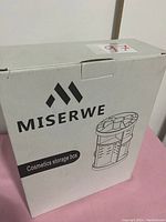 Box of Miserwe cosmetics storage box with black line drawing of the organizer on front showing multiple compartments.