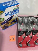Two multi-task glue guns box and four boxed selfie wands in original packaging