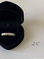 Sterling silver ring in heart-shaped black velvet box