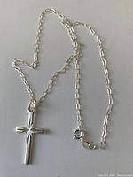 Photo showing the cross pendant and part of the linked chain with lobster clasp.
