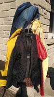 Photo of six items hanging on rack: red Armani Exchange coat, black Ralph Lauren quilted blazer, mustard yellow jacket, and denim and blue jackets on sides