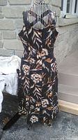 Linen sleeveless dress on mannequin with a floral pattern in shades of black, brown, and beige, tag inside shows Coldwater Creek size 8.