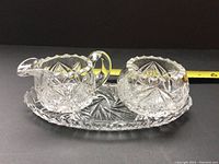 Cream pitcher, sugar bowl with lid, and serving tray shown together from above.