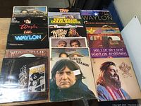Top view of the lot showing several LP album covers including Willie Nelson and Waylon Jennings prominently in the front.