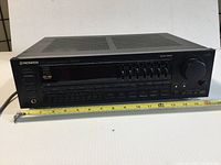 Front view of Pioneer VSX-401 stereo receiver showing control panel, buttons, knobs, and power, headphone jack.