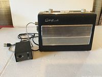 Front view of Sudfunk radio with attached power cord and AC adapter box.