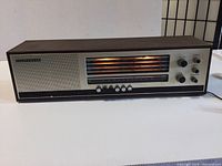 Full front view of Telefunken multi-band radio showing wood grain casing, large illuminated frequency dial and controls.