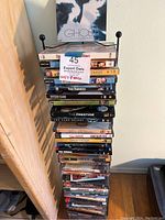 Stack of DVDs and Blu-rays in original cases arranged in a vertical stack showing titles like Ghost, Young Frankenstein, Citizen Kane, The Prestige.