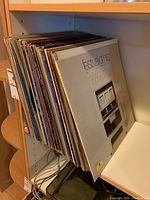 Photo showing a large collection of vinyl albums stored vertically on a shelf, assorted album covers visible.