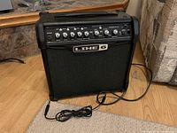 Line 6 Spider IV 15 watt guitar amplifier angled front view showing power cord and control panel.