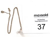 White background photo showing full chain with large white pearl pendant attached and a spring ring clasp.