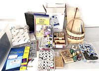 Wide view of craft lot showing spools of thread, rubber stamps, baskets, mailing labels, and other craft accessories.