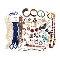 Top-down view of the full jewelry lot spread displaying necklaces, bracelets, earrings, and brooches.