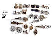 Overview of 28 items including various men's cufflinks, tie clips, and pins arranged on white background.