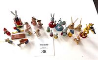 Full collection of 21 small hand-painted wooden figurines in various animal shapes and characters, shown together.