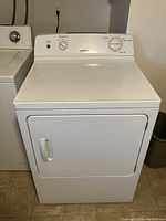 Full front view of the white Hotpoint clothes dryer showing door, handle and control panel with dials.