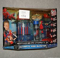 Front view of Spider-Man 3 Ultimate Web Blaster in original box showing wear and sealed toy inside.
