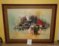 Full front image showing framed abstract painting with a mix of colors and signature.