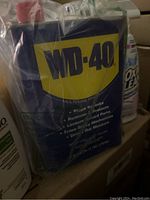 Pack of WD-40 multi-use product cans, sealed with plastic.