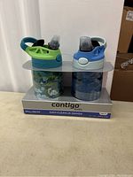 Front view of the two Contigo kids water bottles in packaging showing spill-proof lids and colorful designs