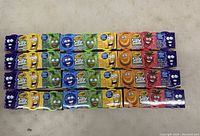 Photo showing multiple boxes of Crayola Silly Scents Dough in colorful packaging arranged in rows.