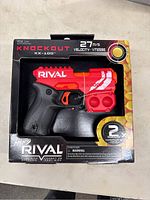 Front of original box showing red and black Nerf Rival Knockout XX-100 blaster toy with branding and velocity info.