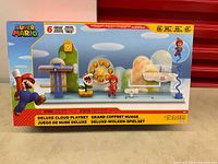 Front view of boxed Super Mario Deluxe Cloud Playset showing included figures and play elements.