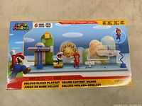 Front of the Super Mario Deluxe Cloud Playset box showing the playset inside and branding.