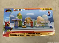 Front image of the unopened Super Mario Deluxe Cloud Playset box showing colorful cloud elements and Mario figure.