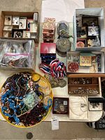 Overview of entire lot: multiple jewelry pieces in boxes, trays, bags