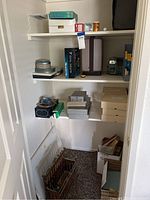 Office closet shelving with multiple film reels, boxes, slide trays, and 8mm movie items stacked and stored