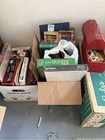 Overview photo showing various puzzle boxes, games, and the farmhouse toy box.