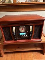 Front view showing the wooden cabinet, speakers, radio dial, and cassette slot.