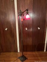 Full view of lamp showing base, shaft, adjustable arm, shade