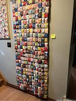 Full frontal view of colorful patchwork quilt hung on rod