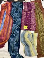 Four scarves in purples, blues, and greens with different fabrics and patterns