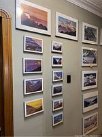 Wall display showing three columns of framed prints of various sizes