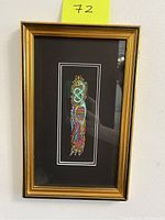 Front view of the framed Celtic art piece showing vibrant colors and gold frame.
