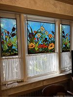Full view of all three stained glass panels hung in window