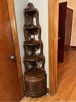 Full view of the assembled corner cabinet showing upper shelves and lower cabinet