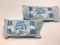 Two sealed packs of Crayola Model Magic blue modeling clay, 28 grams each, placed on a white surface.