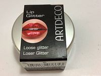 Box packaging of ARTDECO Lip Glitter loose glitter with an image of lips with red glitter and product name.