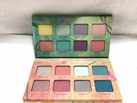 Photo of open eyeshadow palette showing all 16 shades with packaging featuring fairy wings and magical theme