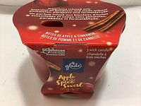 Closed packaging of Glade Apple Spice Swirl candle showing brand, scent and product details.