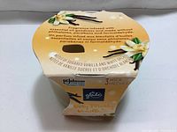 Top view of candle packaging showing scent description and branding.