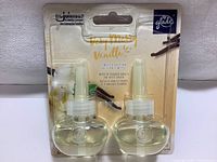 Front view of packaging showing two Glade air freshener refill bottles in Very Merry Vanilla Embrace scent