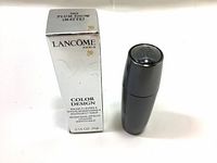 Photo of the Lancome Color Design lipstick box and lipstick case showing product details and shade 380 Plum Show Matte